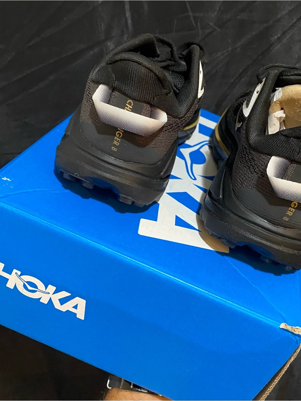Hoka woman’s Black Trail Sneakers with White Heel Loop